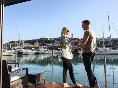 Two people standing on the deck of The Shells